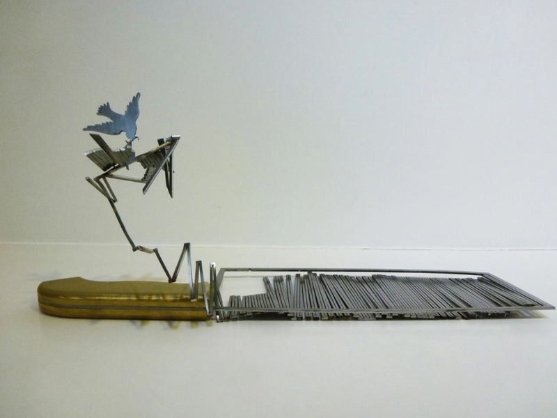Illustration for article titled Intricate shadow silhouettes carved out of butcher's knife blades
